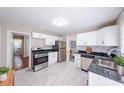 Clean, bright kitchen featuring white cabinets, modern appliances, and sleek countertops with a stainless steel sink at 1251 Richland Sw Rd, Atlanta, GA 30310