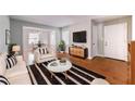 Bright living room showcasing modern decor, hardwood floors, and an open layout leading to the dining area at 1251 Richland Sw Rd, Atlanta, GA 30310