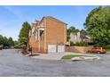 Brick home features an attached two-car garage and a well-maintained yard with mature trees at 1711 Summit Glen Ln, Atlanta, GA 30329