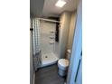 A modern bathroom featuring a corner shower with a rainfall shower head and a sleek toilet at 3042 Humphries Hill Rd, Austell, GA 30106