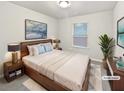 Cozy bedroom featuring neutral walls, plush bedding, and a bright window at 3282 Spicy Cedar Ln, Lithonia, GA 30038