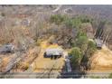 Aerial view of a home with mature trees and a long driveway at 4094 Yancey Rd, Douglasville, GA 30135