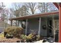 Inviting porch area with ceiling fans and shade, lined with potted plants at 1302 Buttercup Ct, Lawrenceville, GA 30044