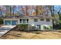 Charming home featuring a two-car garage, complemented by a welcoming front porch and lush surroundings at 3310 Bryan Way, Marietta, GA 30008