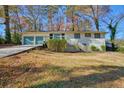 Charming home featuring a two-car garage, complemented by a welcoming front porch and lush surroundings at 3310 Bryan Way, Marietta, GA 30008