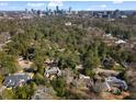 Scenic aerial view of a leafy neighborhood with mature trees and a skyline of the city in the distance at 3330 Habersham Rd, Atlanta, GA 30305