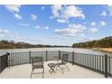 Scenic lake view from balcony with comfortable seating, ideal for relaxing and entertaining guests at 8 Colonial Club Se Dr, Acworth, GA 30102