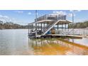 Multi-level private dock overlooking the serene lake, perfect for boating and enjoying waterfront living at 8 Colonial Club Se Dr, Acworth, GA 30102