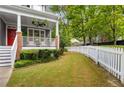 Spacious backyard features a well-maintained lawn with a charming white picket fence and lush greenery at 2149 Whittier Nw Pl, Atlanta, GA 30318