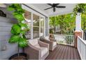 Relaxing front porch featuring wicker furniture, ceiling fan and view of the landscaped front yard at 2149 Whittier Nw Pl, Atlanta, GA 30318