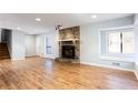 Spacious living room features a stone fireplace, hardwood floors, and a cozy window seat at 3485 Sheree Trl, Stone Mountain, GA 30087