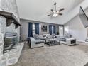 Open-concept living room with stone fireplace, plush sectional sofa, and modern decor at 1036 Pinetree Ct, Powder Springs, GA 30127