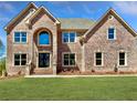 Stunning two-story brick home with a manicured lawn, and a double door entrance at 254 Lotus Ln, Covington, GA 30016