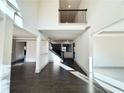 Bright foyer with dark hardwood floors, a high ceiling, and wrought iron staircase at 254 Lotus Ln, Covington, GA 30016