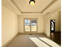 Bright living room featuring plush carpeting, recessed ceiling lighting, and a large window with natural light at 254 Lotus Ln, Covington, GA 30016