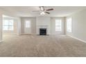 Spacious living room featuring a fireplace, neutral paint, and plush carpet flooring at 3127 Leyland Ct, Decatur, GA 30034