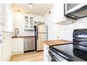 Bright kitchen featuring stainless appliances, butcher block counters, white cabinetry, and subway tile backsplash at 589 Auburn Ne Ave # F, Atlanta, GA 30312