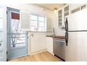 A compact kitchen with stainless steel appliances, white cabinets, and wood countertops at 589 Auburn Ne Ave # F, Atlanta, GA 30312