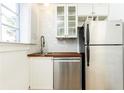 Well-lit kitchen with stainless steel appliances, butcher block countertop, and white cabinets, offering a functional space at 589 Auburn Ne Ave # F, Atlanta, GA 30312