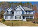 Beautiful two-story home with classic architectural details, manicured lawn, and inviting curb appeal at 3198 Highland Forge Trl, Dacula, GA 30019