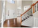 Grand foyer with soaring ceilings, hardwood flooring, and a staircase featuring decorative ironwork at 3198 Highland Forge Trl, Dacula, GA 30019