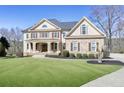 Stunning two-story home with a well-maintained lawn, brick and siding accents, and a welcoming walkway at 3433 Pinemont Dr, Douglasville, GA 30135