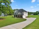 Spacious two-story home with a long driveway and a well-manicured lawn at 1300 Snapping Shoals Rd, Mcdonough, GA 30252