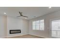 Cozy living room with a modern fireplace, neutral paint, and large windows offering ample natural light at 3336 Cranston Ln, Kennesaw, GA 30144