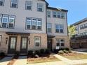 Attractive townhome features gray siding, brick accents, and a welcoming front entrance at 3987 Allegretto Cir # 250, Atlanta, GA 30339