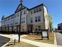 Attractive townhome community features gray siding, brick accents, and meticulous landscaping at 3987 Allegretto Cir # 250, Atlanta, GA 30339