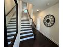 Inviting foyer with staircase, dark hardwood floors, and elegant decor at 3987 Allegretto Cir # 250, Atlanta, GA 30339