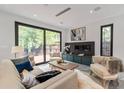 Inviting living room with stylish furniture, a modern fireplace, and large glass doors opening to the outdoors at 1653 Wayland Ne Cir, Brookhaven, GA 30319