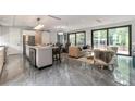 Open concept living area featuring sleek tile floors, modern furnishings, and seamless flow to outdoor living spaces at 1653 Wayland Ne Cir, Brookhaven, GA 30319