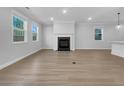Spacious living room with fireplace, hardwood floors, and plenty of natural light at 3624 Silvery Way, Powder Springs, GA 30127