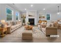 Bright living room featuring a cozy fireplace, neutral decor, and large windows at 3624 Silvery Way, Powder Springs, GA 30127