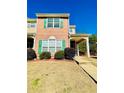 Well-maintained townhome showcasing brick facade, manicured landscaping, and covered entry at 5070 Oakley Commons Blvd, Union City, GA 30291