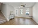 Bright living room featuring wood floors, a ceiling fan, and natural light at 83 Arnold Poplar Ln, Auburn, GA 30011