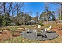 A spacious backyard features an outdoor seating area with chairs arranged around a fire pit at 1031 Willivee Dr, Decatur, GA 30033