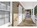 Covered porch with neutral siding and wood-look flooring at 1477 Akridge Nw St, Atlanta, GA 30314