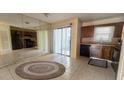 Open kitchen area featuring tile floor, mirrored wall and sliding glass door at 2173 Wellington Cir, Lithonia, GA 30058