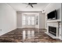 Living room featuring hardwood floors, fireplace, and large windows at 850 Piedmont Ne Ave # 1302, Atlanta, GA 30308