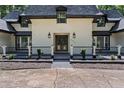 Elegant entryway featuring custom double doors and a professionally landscaped garden at 2023 Stoneleigh Dr, Stone Mountain, GA 30087