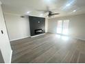 Modern living room featuring sleek hardwood floors, ceiling fan, and a stylish fireplace at 3078 Parc Lorraine, Lithonia, GA 30038