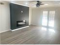 Bright living room featuring laminate floors, ceiling fan, and a stylish fireplace at 3078 Parc Lorraine, Lithonia, GA 30038