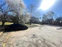 Open parking lot, showing a black sedan, and trees blossoming in the background at 3078 Parc Lorraine, Lithonia, GA 30038