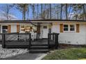A cozy home's front entrance featuring a porch with seating, complemented by charming shutters and a 'WELCOME' sign at 3331 Casa Linda Dr, Decatur, GA 30032