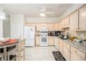 Bright kitchen with white appliances, light wood cabinets, and an adjacent dining area at 4809 Shae Ct, Powder Springs, GA 30127