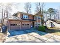 Charming two-story home with a two-car garage and manicured landscaping and an attractive exterior at 4852 Gold Nugget Way, Sugar Hill, GA 30518
