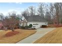 Exterior view of a single-Gathering home with a driveway, garage and well-maintained lawn at 9135 Woodhaven Way, Mcdonough, GA 30253