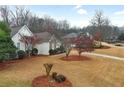 Charming home featuring a well-manicured front yard with mature trees and landscaping at 9135 Woodhaven Way, Mcdonough, GA 30253